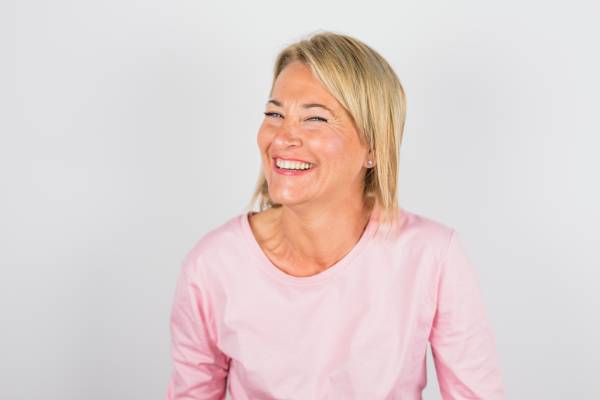 senior laughing woman rose blouse